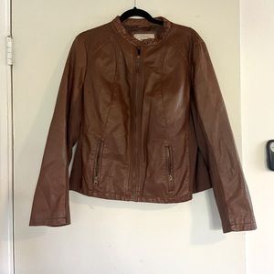 Brown faux leather jacket with stretchy fabric panels in sleeves